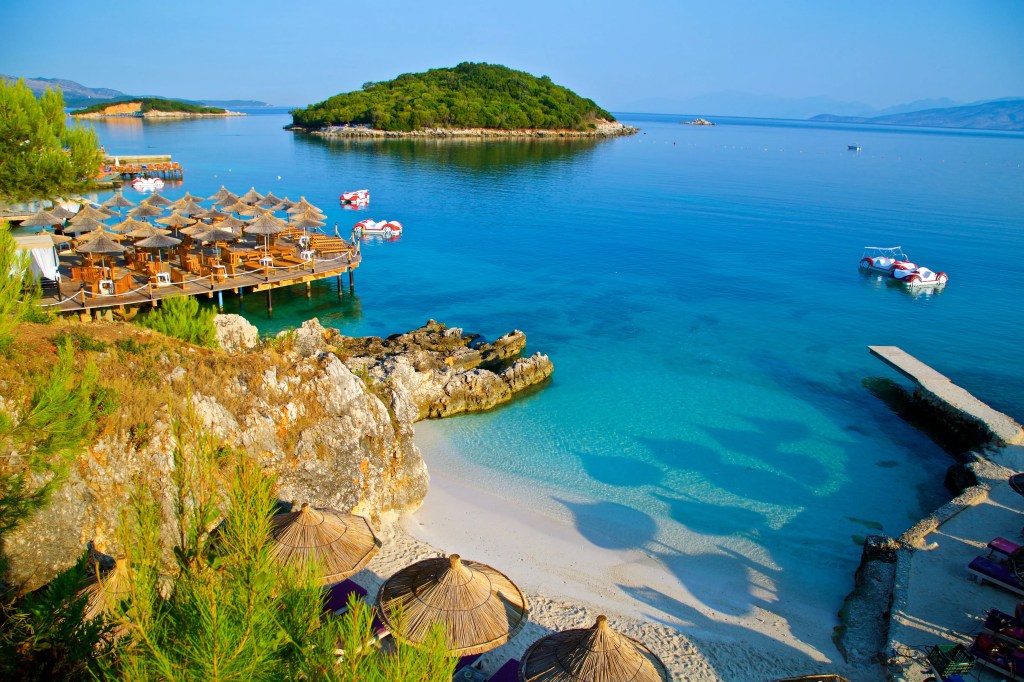 Wide beach view of the Albanian Riviera with turquoise sea and sunlit shore