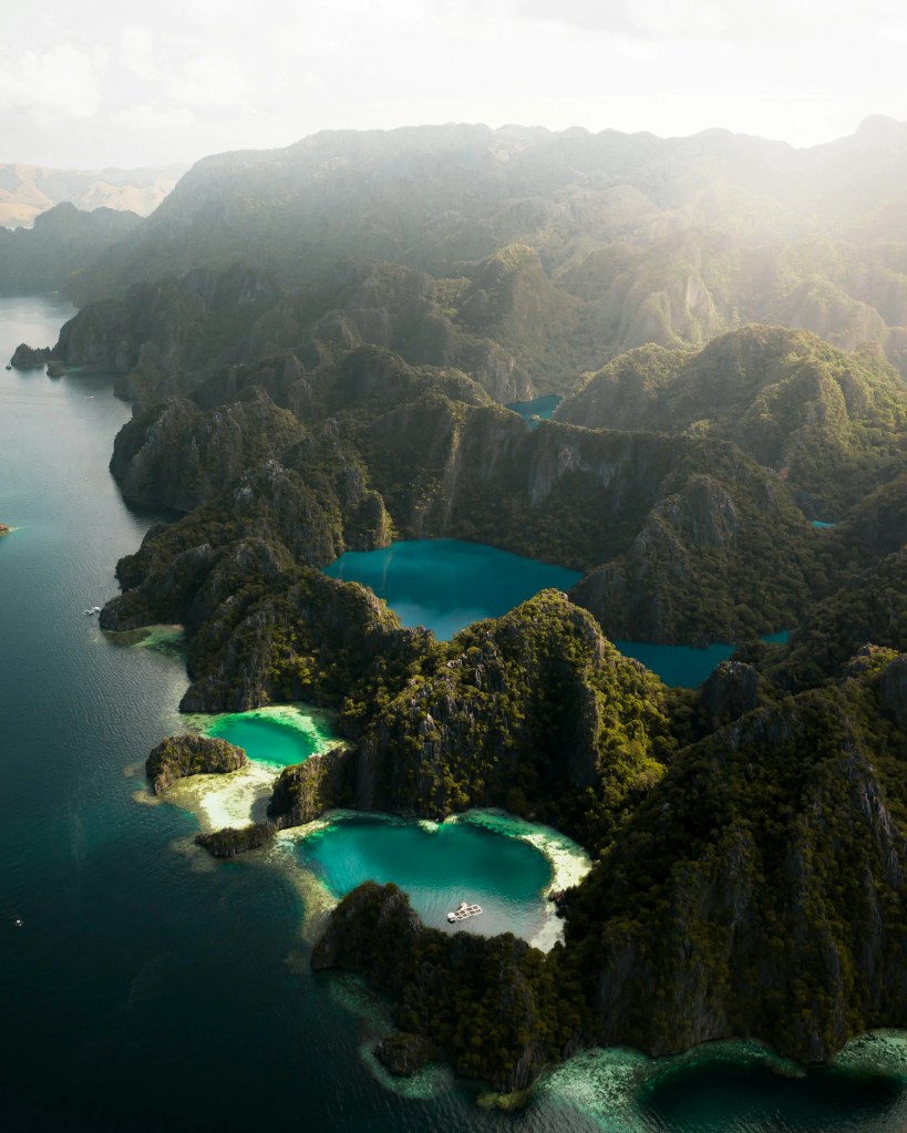 White-sand beach and crystal-clear turquoise water at Malcapuya Island, Coron, Palawan