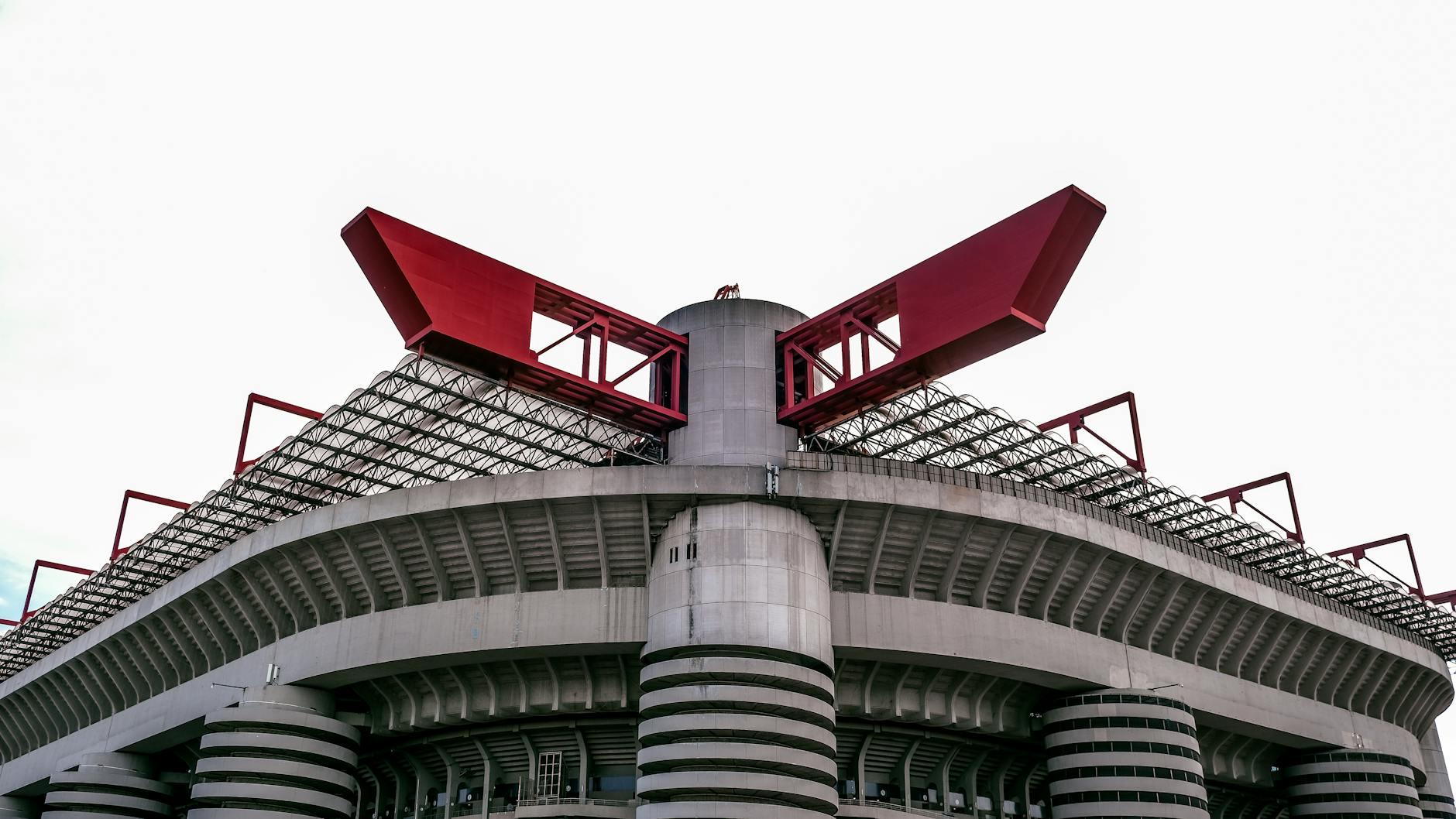 View of San Siro Stadium, featuring its distinctive red architectural accents and modern design.