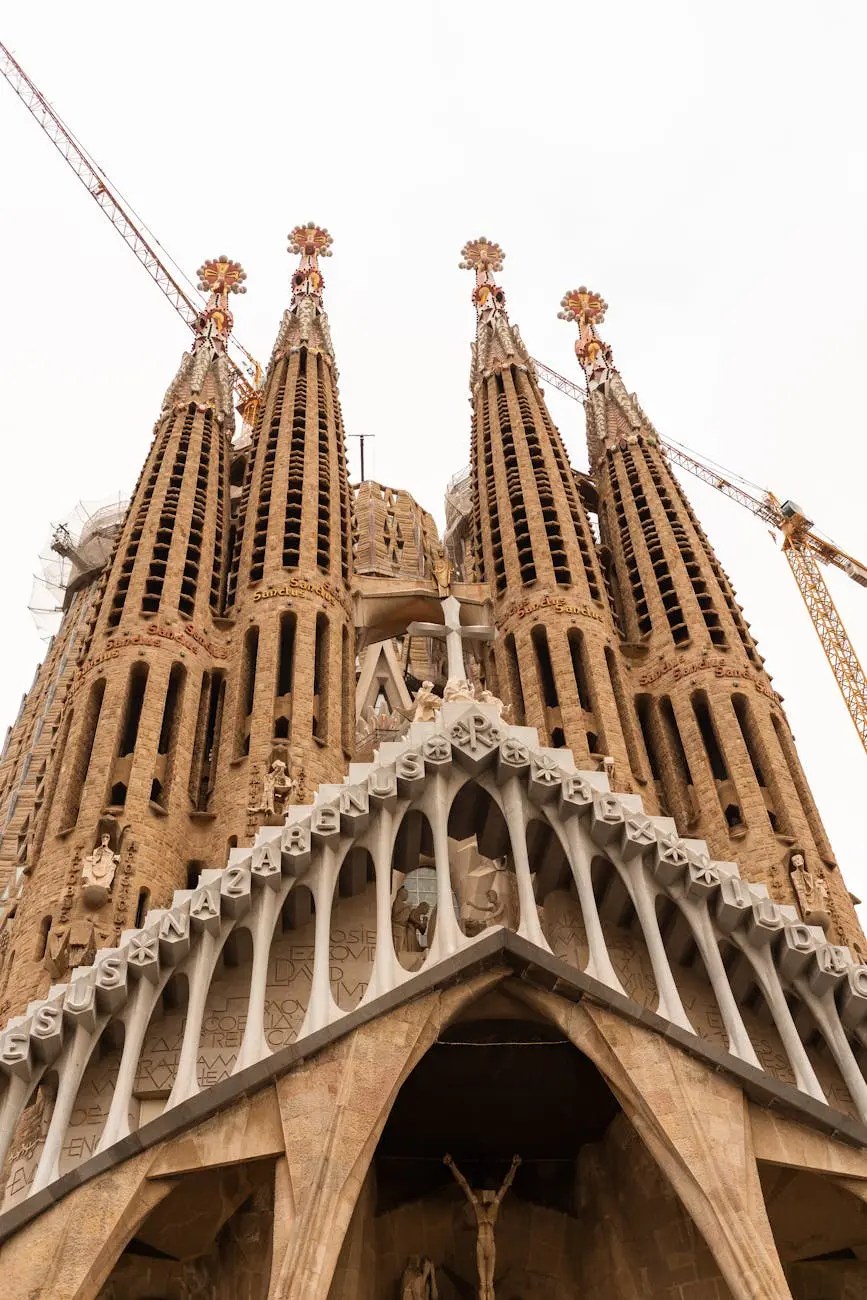 Close-up view of the Sagrada Família, showcasing its intricate architectural details and towering spires against a cloudy sky.