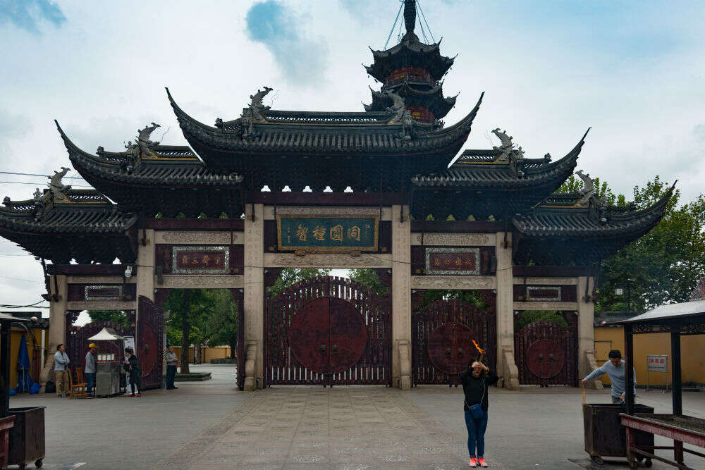 Entrance gate of the Yu Garden in Shanghai, featuring traditional Chinese architecture with ornate rooftops and large wooden doors.