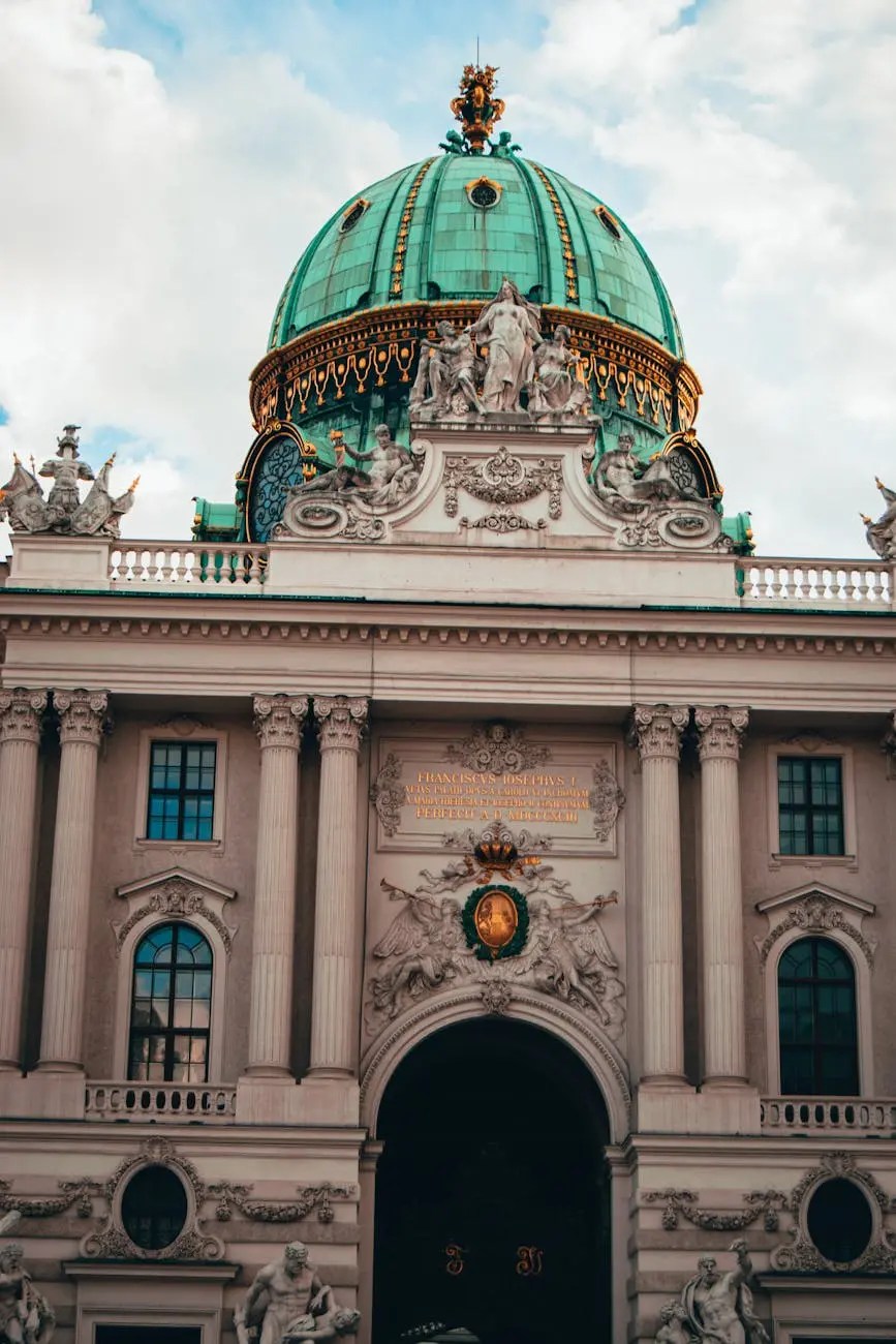 Close-up view of the ornate architecture of the Hofburg Palace in Vienna, highlighting its green dome and intricate sculptures.