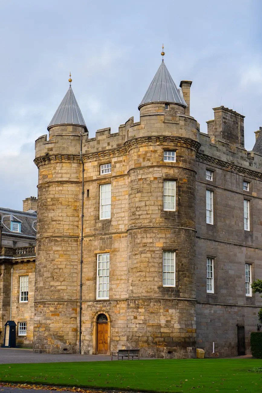 Close-up view of a stone building with turreted roofs, showcasing historic architecture and window details.