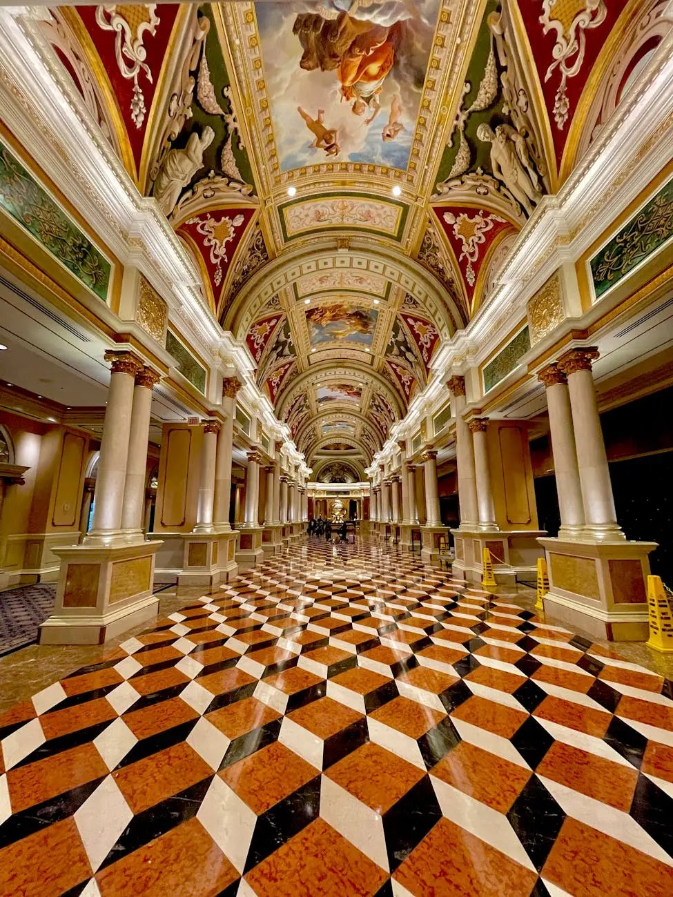 Intricate interior of The Venetian in Las Vegas, showcasing ornate frescoes on the ceiling and a stylish, geometric patterned floor.