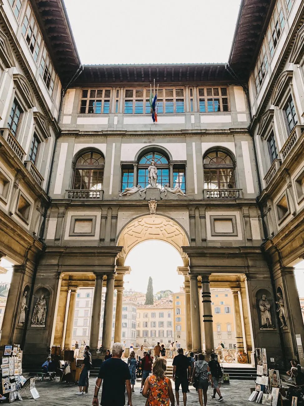 Interior view of the Uffizi Gallery in Florence, Italy, showcasing the architectural details and visitors exploring the space.