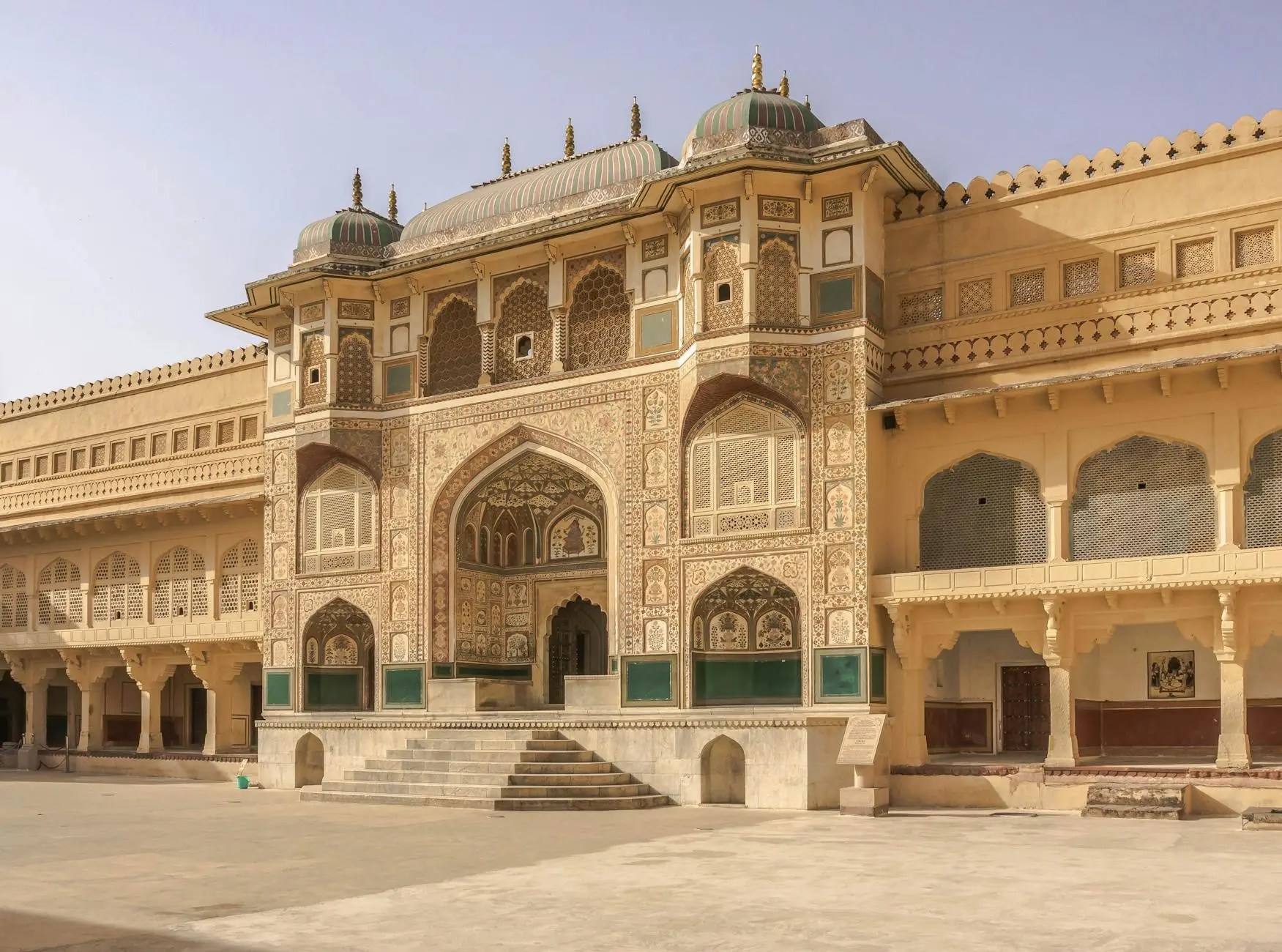 View of the intricately designed entrance of Amber Fort in Jaipur, India, showcasing traditional Rajasthani architecture with detailed carvings and vibrant colors.