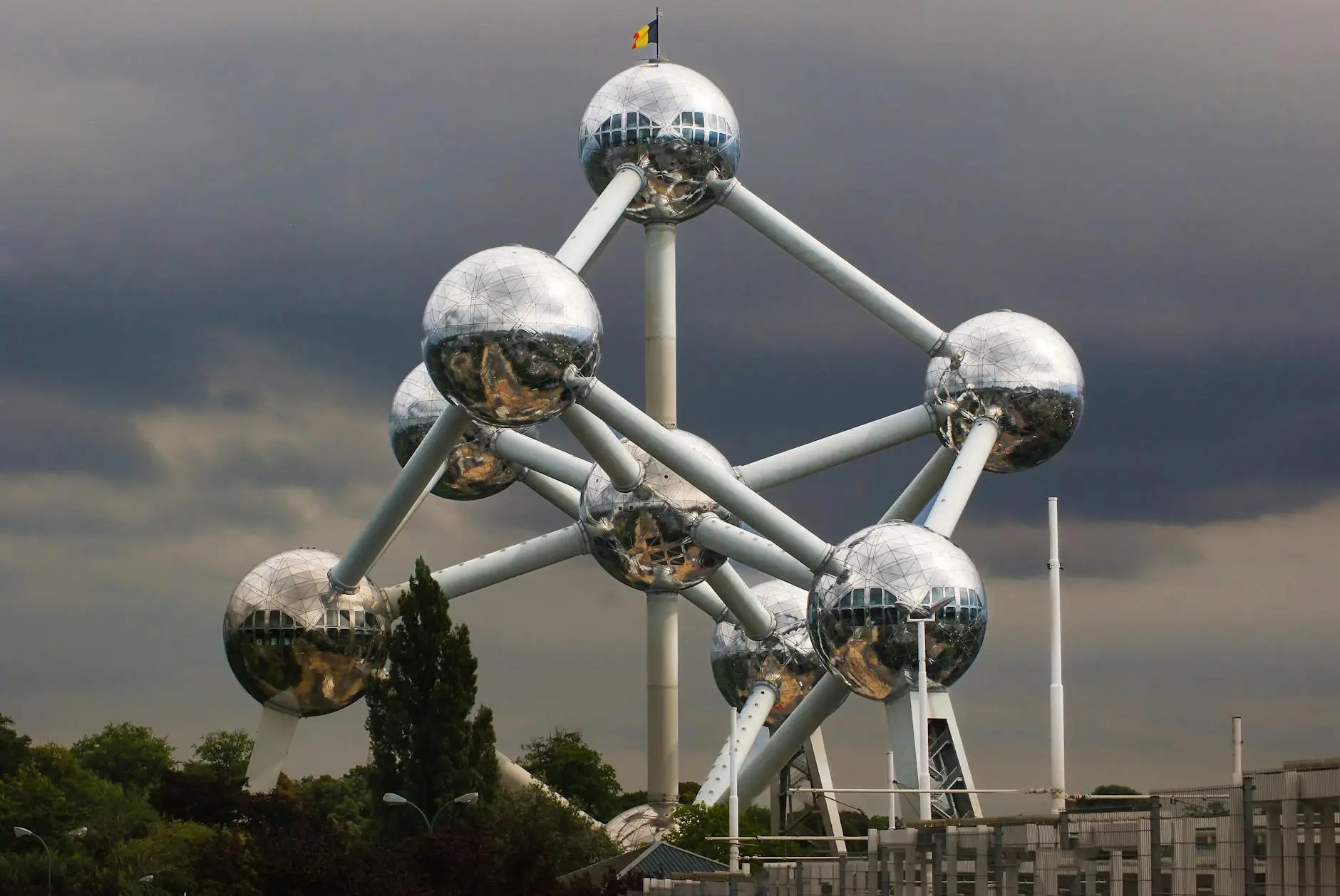 This image captures the magnificent scale and unique design of the Atomium, one of Brussels' most recognizable landmarks. The structure, consisting of nine stainless-steel-clad spheres connected by tubes, towers over Heysel Park. Originally constructed for the 1958 World Expo, it symbolized postwar optimism and faith in scientific progress. Today, it functions as a museum and viewpoint, with several spheres open to the public. Visitors can explore exhibitions on its history and the 1950s, and ascend to the top sphere for a breathtaking 360-degree panoramic view of Brussels. Its futuristic, enduring silhouette makes it a must-see contrast to the city's medieval Grand-Place.