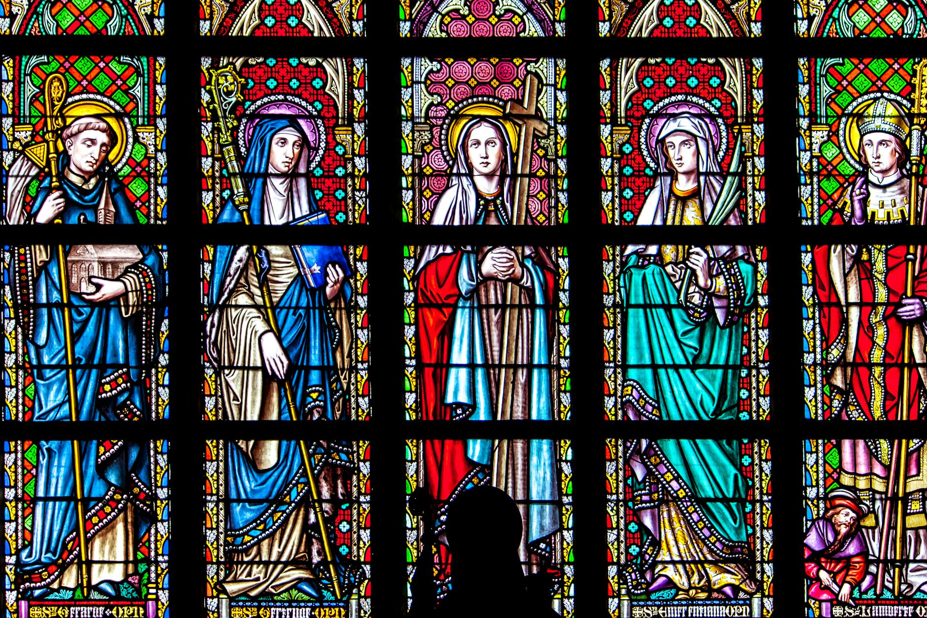 Stained glass window depicting religious figures in vibrant colors.