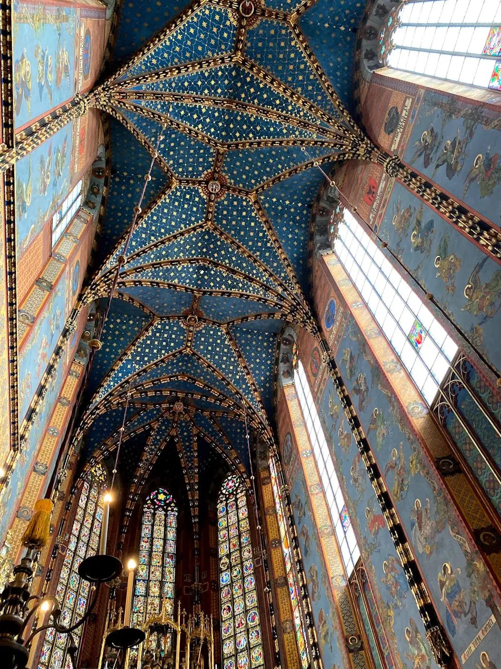 Interior view of a beautifully decorated church, showcasing a blue ceiling adorned with golden stars and intricate artwork.
