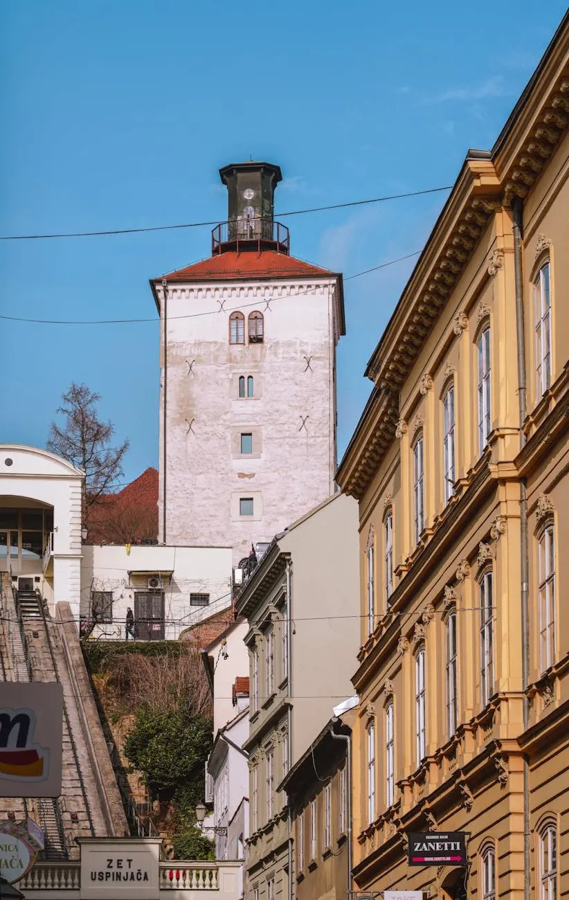 View of the Lotrščak Tower in Zagreb, Croatia, surrounded by historical buildings and a funicular railway.