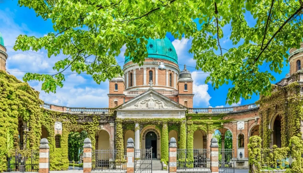 A picturesque view of Mirogoj Cemetery in Zagreb, Croatia, showcasing its beautiful architecture adorned with lush greenery and a clear blue sky.