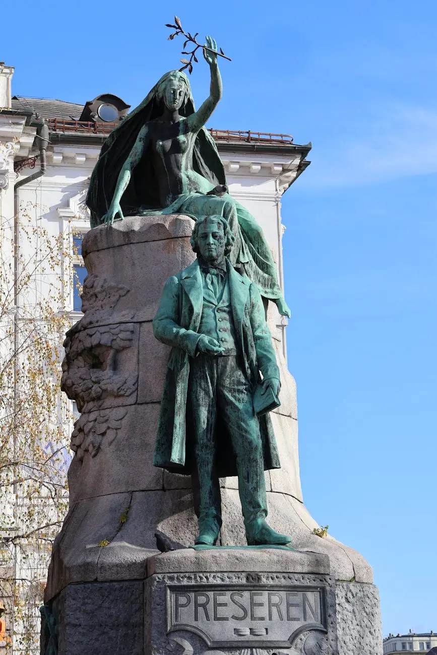 A bronze monument of a poet, featuring a seated female figure holding a laurel branch above a standing man. The sculpture is set against a clear blue sky.
