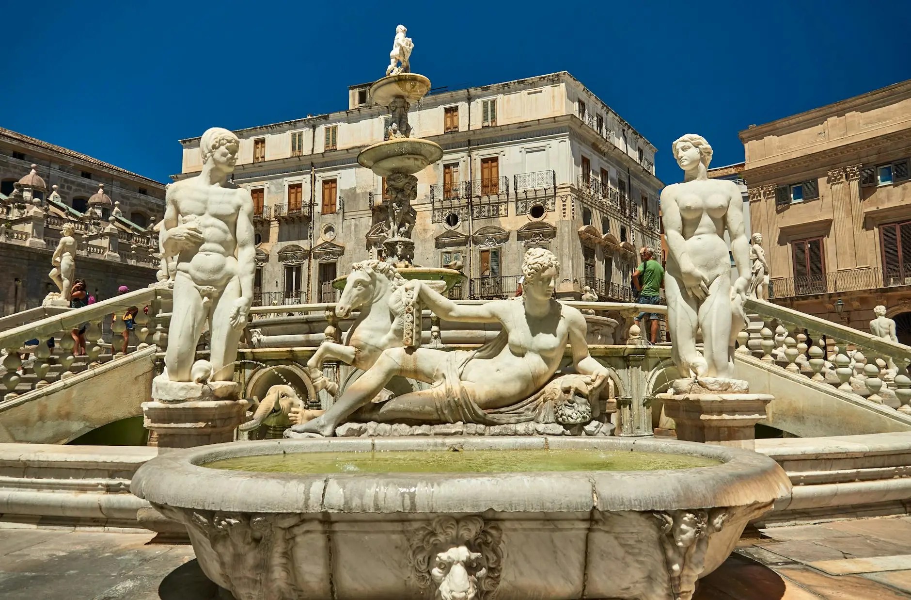 Aerial view of the monumental Fontana Pretoria (Fountain of Shame) in Piazza Pretoria, Palermo, featuring concentric tiers of Renaissance marble statues and basins.